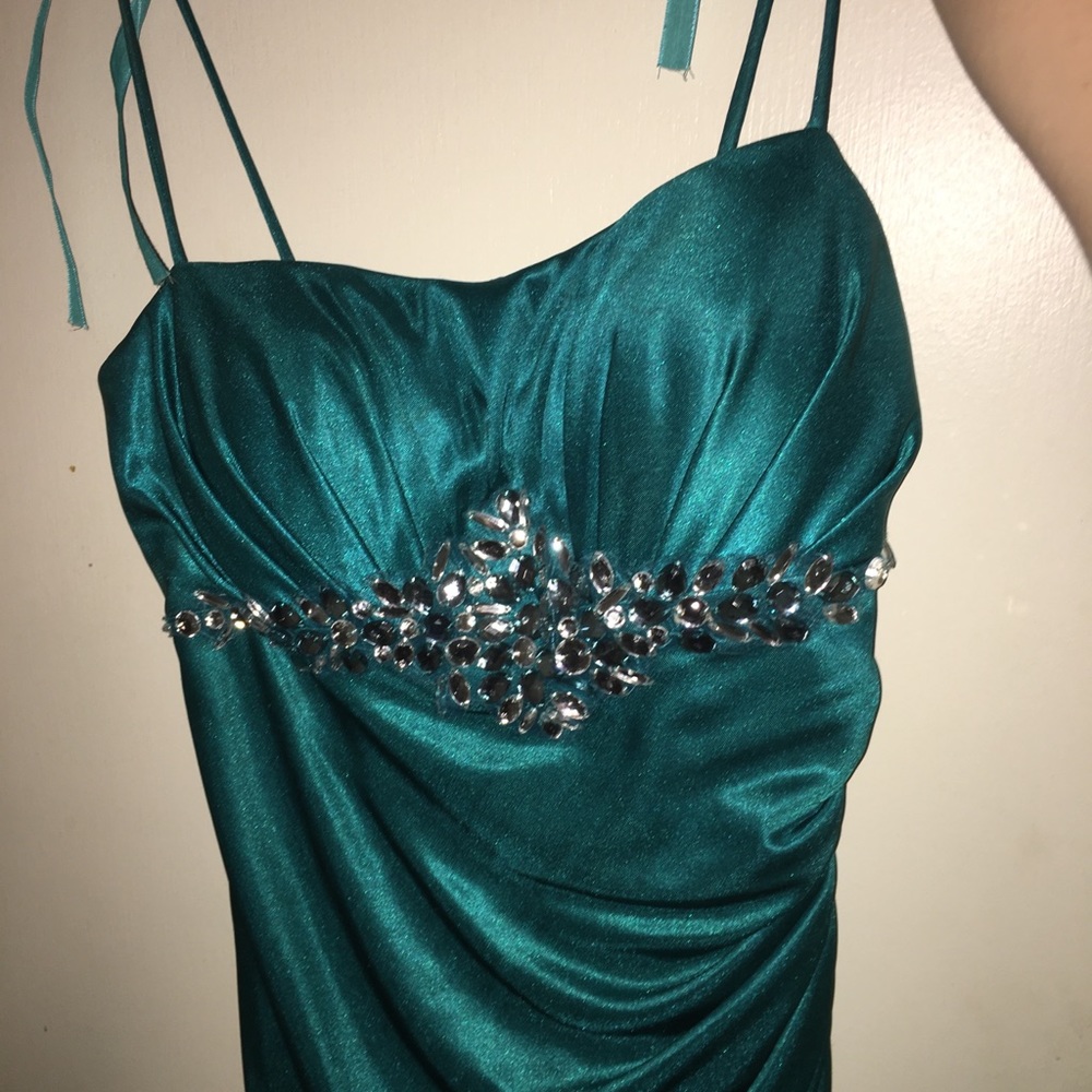 A blue floor length spaghetti strap dress.